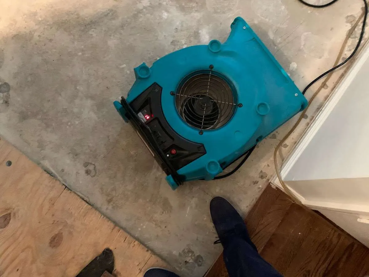 Air mover drying subfloor during Commercial Water Damage Restoration in Randallstown